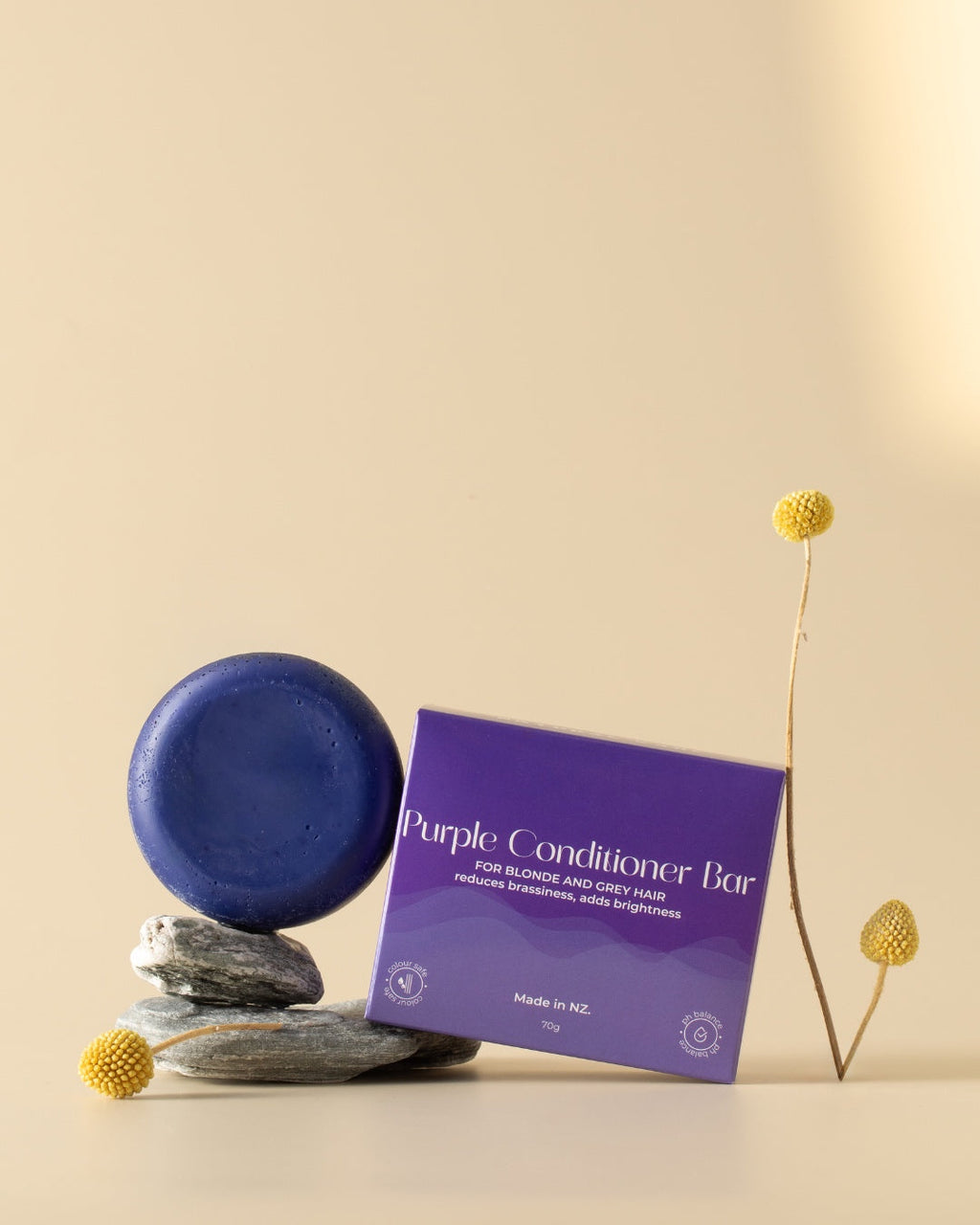 Purple conditioner bar with packaging on a beige background